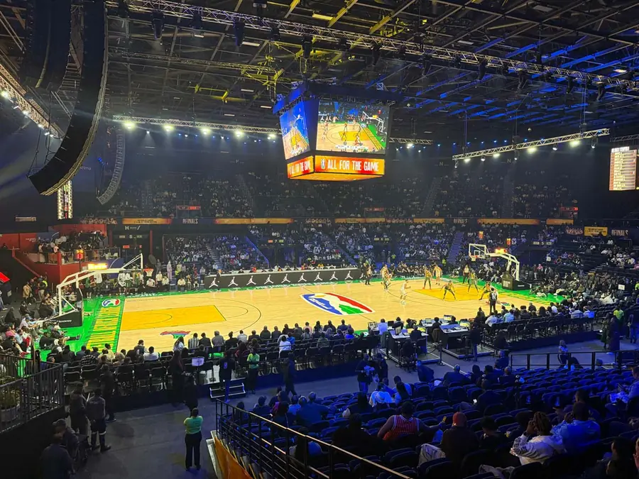 Basketball Africa League arena with branded court, spectator seating and broadcast lighting