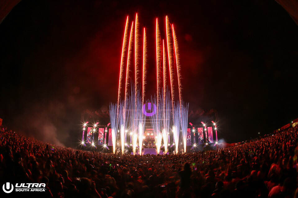 Ultra Music Festival nighttime crowd facing a brightly lit electronic music stage in Cape Town