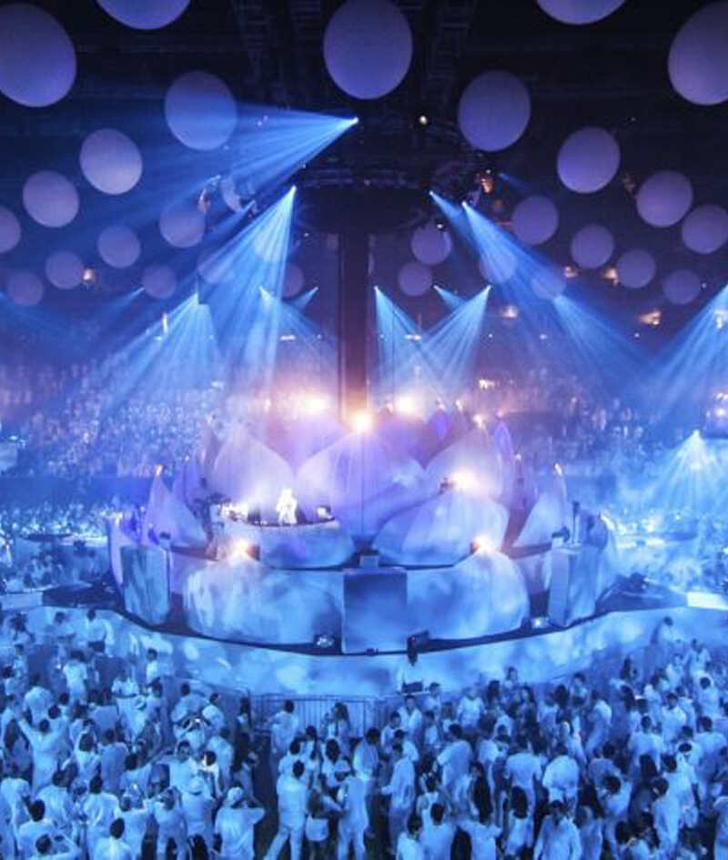 Sensation Innerspace crowd in white beneath a large suspended showpiece and immersive lighting